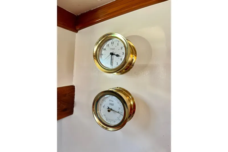 Slide: The Image of Brass clock and barometer on 1975 Cape George 36 boat interior wall. - 56