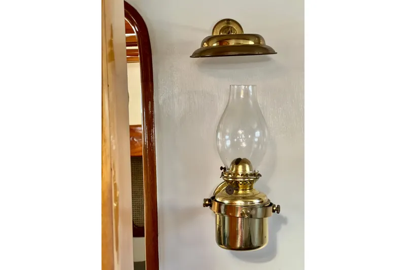 Slide: The Image of Brass oil lamp on Cape George 36, 1975 model, wooden interior detail. - 57