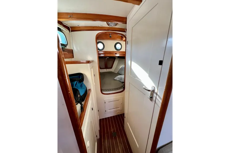 Slide: The Image of Interior of 1975 Cape George 36 sailboat with cozy cabin and wooden accents. - 61