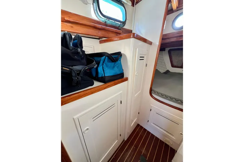 Slide: The Image of Interior of 1975 Cape George 36 sailboat with storage and sleeping area. - 63