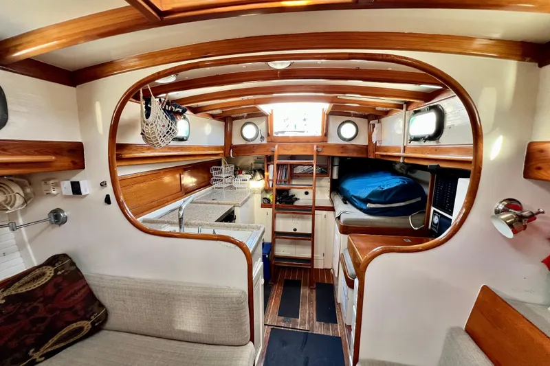 Slide: The Image of Interior of a 1975 Cape George 36 sailboat with wooden accents and cozy seating. - 66