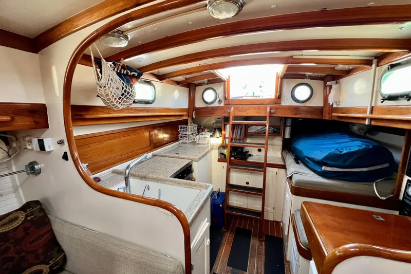 Slide: The Image of Interior of a 1975 Cape George 36 sailboat with wooden accents and cozy living space. - 67