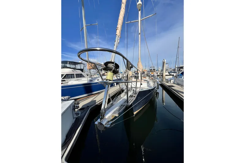 Slide: The Image of 1975 Cape George 36 sailboat docked in marina under clear blue sky. - 7