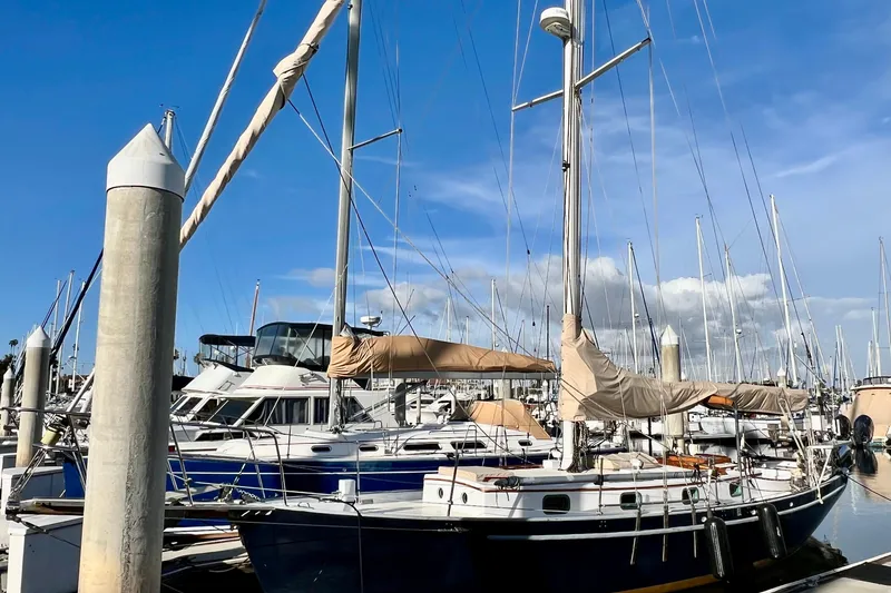 Slide: The Image of 1975 Cape George 36 sailboat docked at marina under clear blue sky. - 9