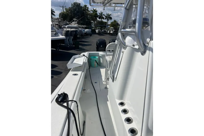 Slide: The Image of 2019 Yellowfin 29 Offshore boat deck with fishing rod holders and seating. - 12