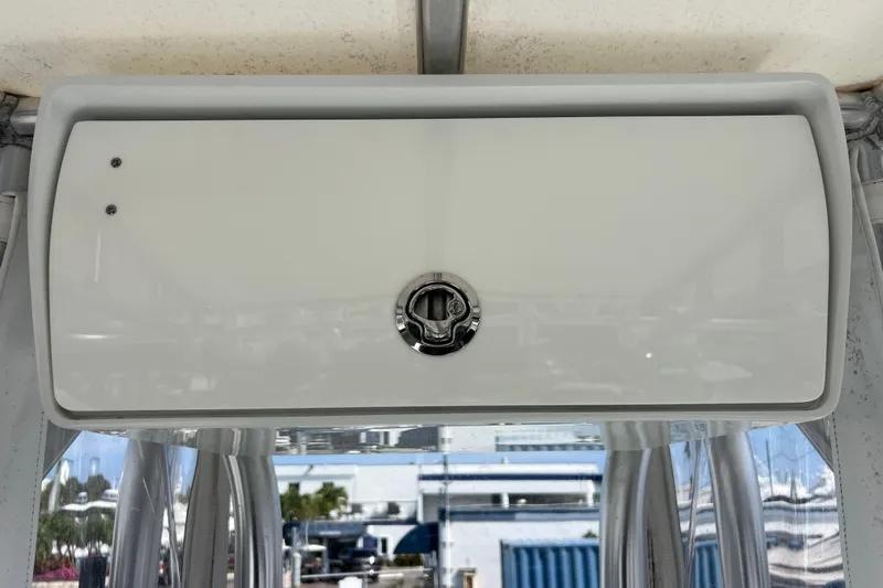 Slide: The Image of 2019 Yellowfin 29 Offshore boat storage compartment with latch, viewed from below. - 18