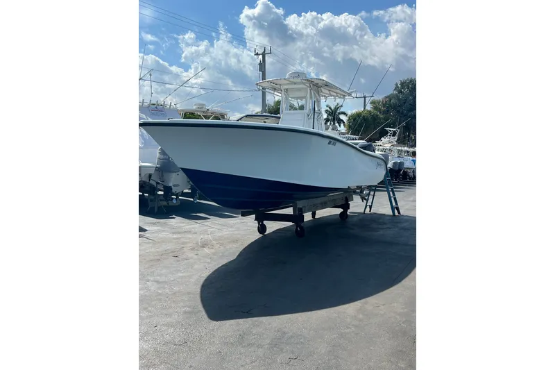 Slide: The Image of 2019 Yellowfin 29 Offshore boat on trailer under a sunny sky. - 19