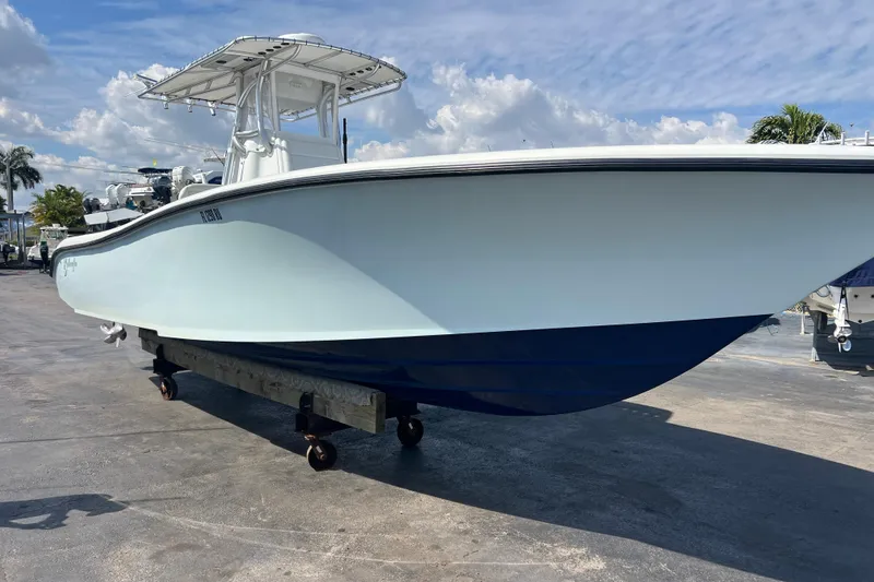 Slide: The Image of 2019 Yellowfin 29 Offshore boat on display under a clear blue sky. - 22