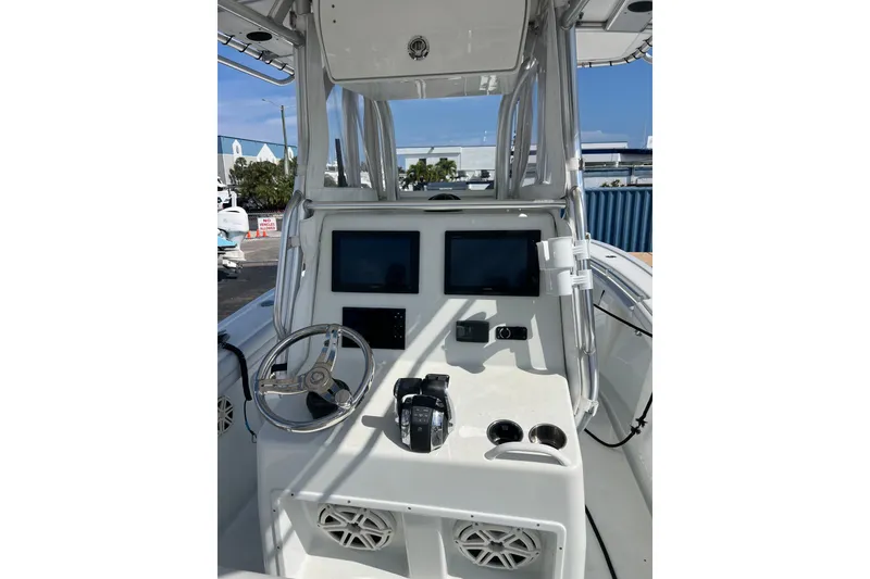 Slide: The Image of 2019 Yellowfin 29 Offshore boat console with steering wheel and navigation screens. - 7