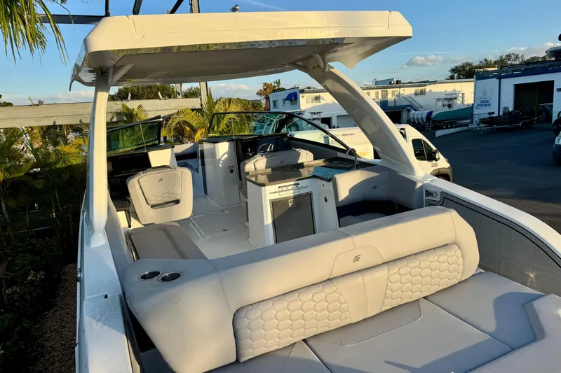 Slide: The Image of 2026 Four Winns H33 OB boat interior with modern seating and sleek design. - 10