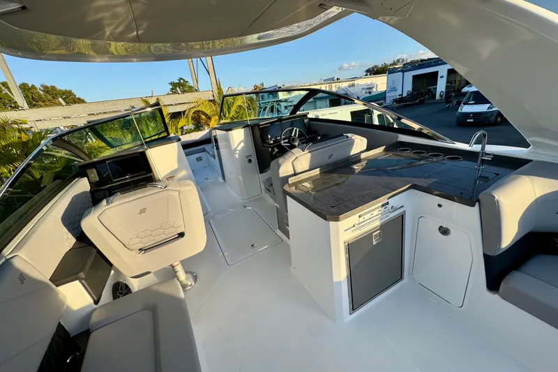 Slide: The Image of 2026 Four Winns H33 OB boat interior with modern seating and sleek design. - 14