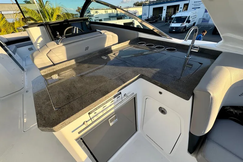 Slide: The Image of Luxury outdoor kitchen on 2026 Four Winns H33 OB boat with sleek countertop and sink. - 15