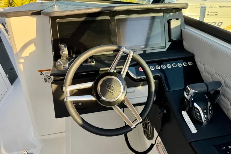 Slide: The Image of 2026 Four Winns H33 OB boat dashboard with steering wheel and control panel. - 18