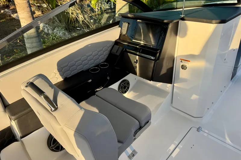 Slide: The Image of Interior of 2026 Four Winns H33 OB boat with modern seating and dashboard. - 19