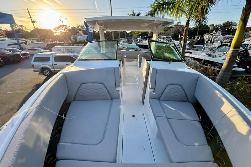 Slide: The Image of 2026 Four Winns H33 OB boat interior with luxurious seating at sunset. - 23