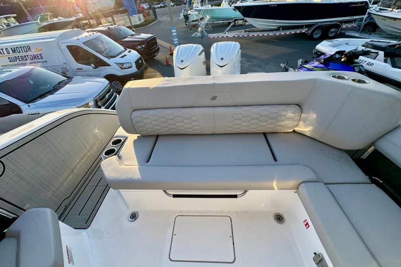 Slide: The Image of 2026 Four Winns H33 OB boat interior with cushioned seating and cup holders. - 32