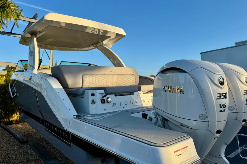 Slide: The Image of 2026 Four Winns H33 OB boat with dual Yamaha 350 V6 engines, sleek design. - 7