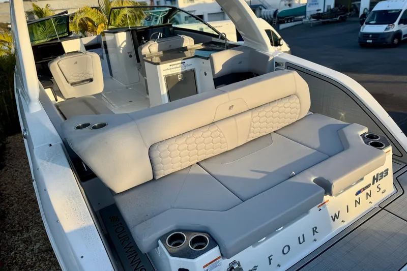 Slide: The Image of 2026 Four Winns H33 OB boat interior with luxurious seating and modern design. - 9