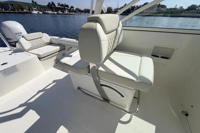 Slide: The Image of 2026 World Cat 230 DC boat interior with comfortable seating and scenic waterfront view. - 7