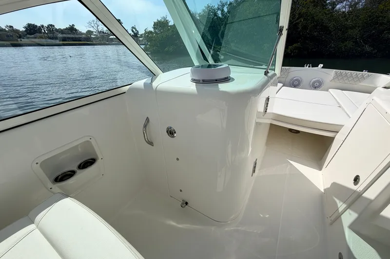 Slide: The Image of 2026 World Cat 230 DC interior with seating and water view. - 8