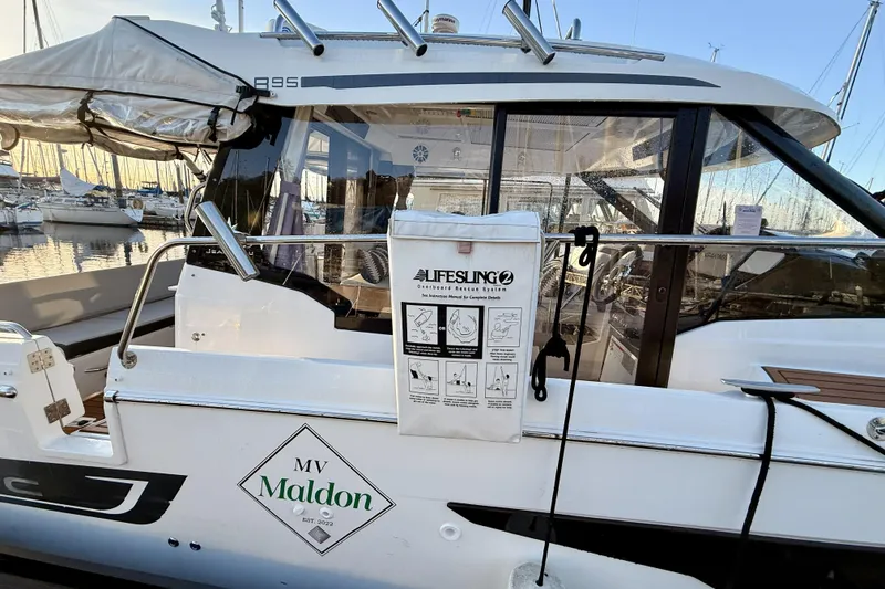 Slide: The Image of 2022 Jeanneau NC Weekender 895 docked, featuring lifesaving equipment and "MV Maldon" signage. - 10