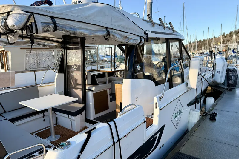 Slide: The Image of 2022 Jeanneau NC Weekender 895 docked, featuring outdoor seating and covered cockpit. - 12