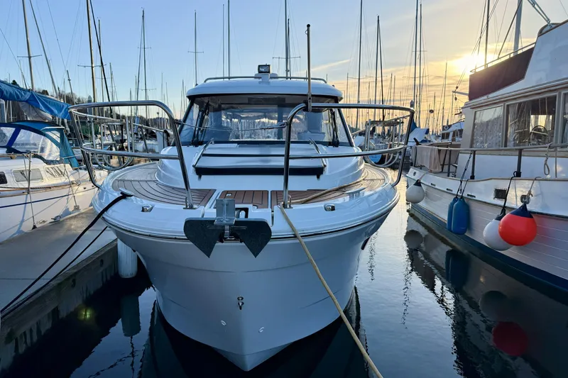 Slide: The Image of 2022 Jeanneau NC Weekender 895 docked at marina during sunset. - 15