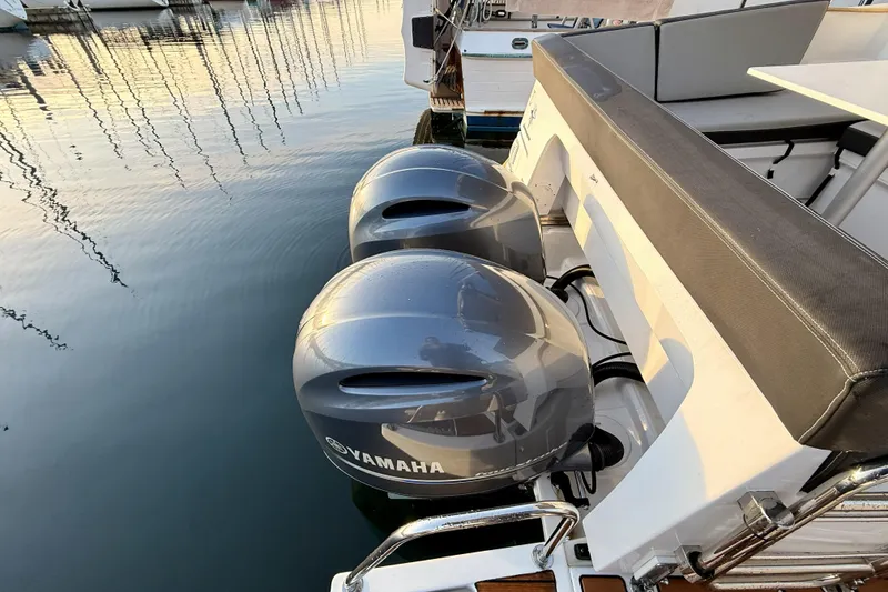 Slide: The Image of 2022 Jeanneau NC Weekender 895 with dual Yamaha outboard motors docked at marina. - 20
