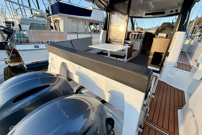 Slide: The Image of 2022 Jeanneau NC Weekender 895 with dual engines, spacious deck, and modern interior. - 21