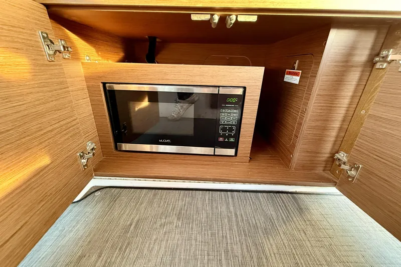 Slide: The Image of Microwave in Jeanneau NC Weekender 895 boat's wooden cabinet, 2022 model. - 26
