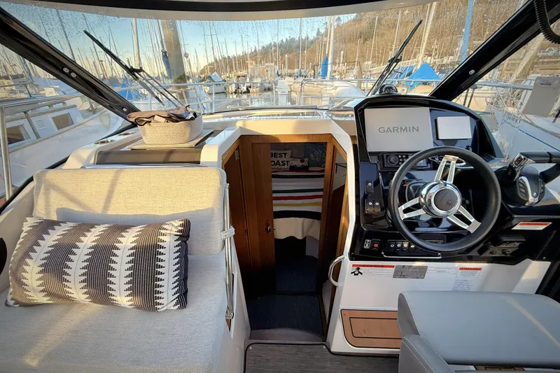 Slide: The Image of Interior of 2022 Jeanneau NC Weekender 895 with steering wheel and Garmin navigation system. - 29