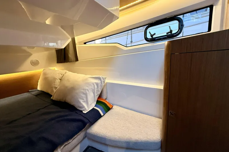 Slide: The Image of Interior cabin of 2022 Jeanneau NC Weekender 895 with cozy bed and window view. - 31