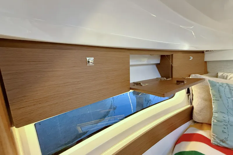 Slide: The Image of Interior of 2022 Jeanneau NC Weekender 895 with wooden cabinetry and window view. - 34