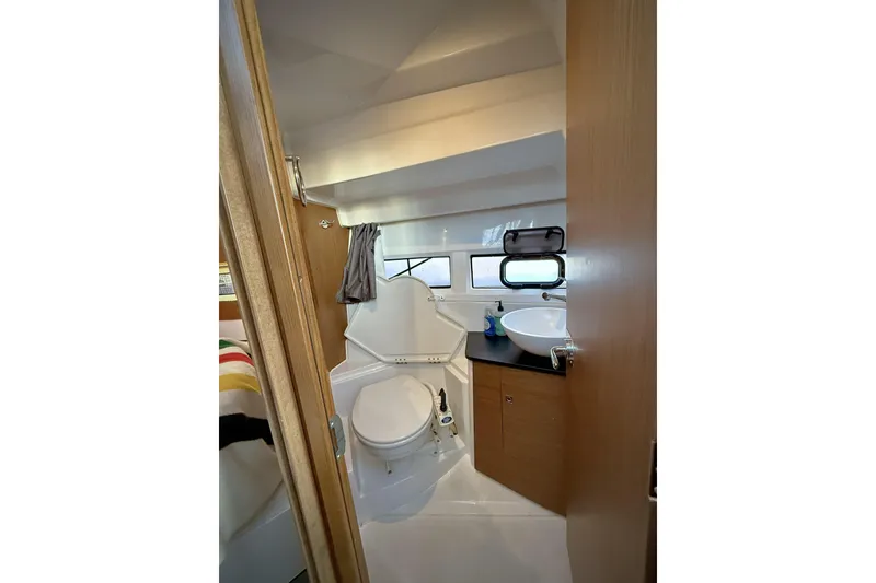 Slide: The Image of Compact bathroom in 2022 Jeanneau NC Weekender 895 boat, featuring toilet and sink. - 36