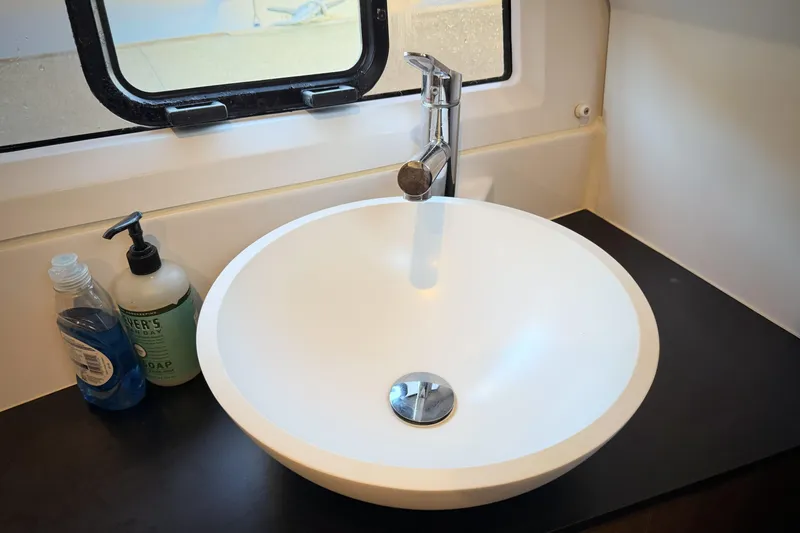 Slide: The Image of Modern bathroom sink in 2022 Jeanneau NC Weekender 895 boat, with soap dispensers. - 37
