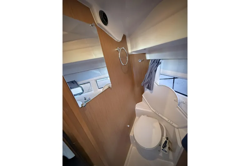 Slide: The Image of Bathroom interior of 2022 Jeanneau NC Weekender 895 boat, featuring toilet and mirror. - 38
