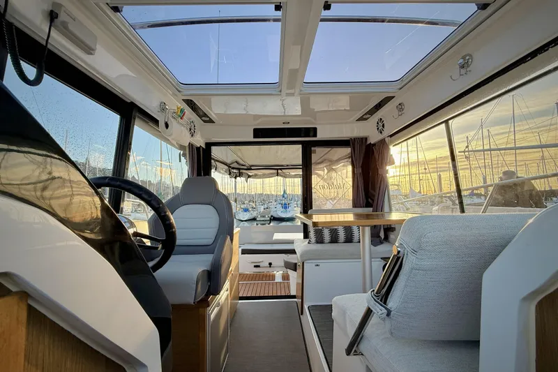 Slide: The Image of Interior of 2022 Jeanneau NC Weekender 895 boat with modern seating and panoramic windows. - 39