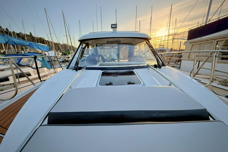 Slide: The Image of 2022 Jeanneau NC Weekender 895 at marina during sunset, surrounded by sailboats. - 42