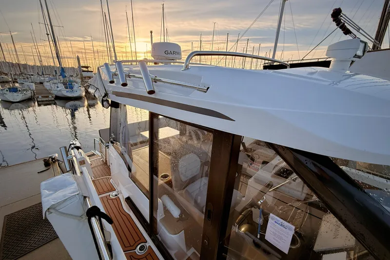 Slide: The Image of 2022 Jeanneau NC Weekender 895 docked at marina during sunset. - 43