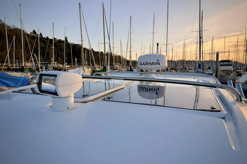 Slide: The Image of 2022 Jeanneau NC Weekender 895 with Garmin equipment, docked at marina during sunset. - 45