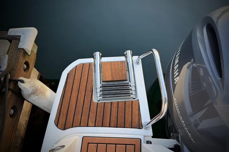 Slide: The Image of 2022 Jeanneau NC Weekender 895 swim platform with teak finish and Yamaha outboard motor. - 48
