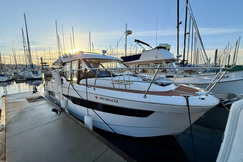Slide: The Image of 2022 Jeanneau NC Weekender 895 docked at marina during sunset. - 8
