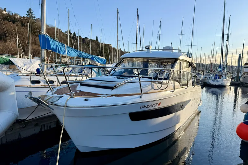 Slide: The Image of 2022 Jeanneau NC Weekender 895 docked at marina, surrounded by sailboats. - 9