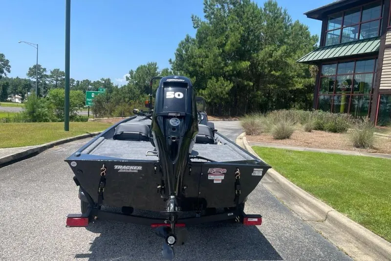 Slide: The Image of 2026 Tracker Bass Tracker Classic XL boat with Mercury 50 engine, parked outdoors. - 3