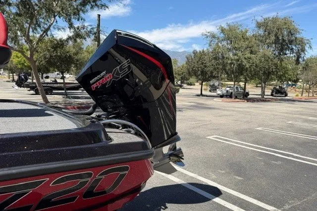 Slide: The Image of 2026 Nitro Z20 XL Pro boat with Mercury Pro XS engine in a parking lot. - 4