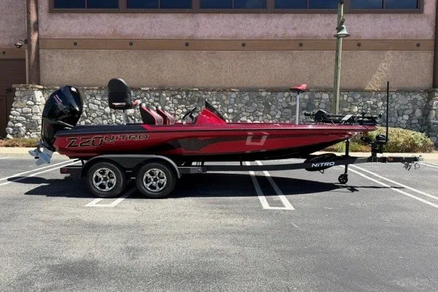 The Image of 2026 Nitro Z20 XL Pro boat on trailer, parked in a lot, side view. - 0