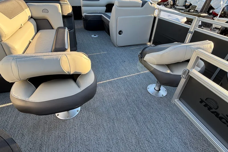 Slide: The Image of 2026 Sun Tracker Fishin' Barge 20 DLX interior with plush seating and spacious layout. - 12