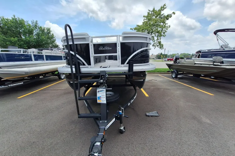 Slide: The Image of 2026 Sun Tracker SportFish 22 DLX pontoon boat on trailer in parking lot. - 3