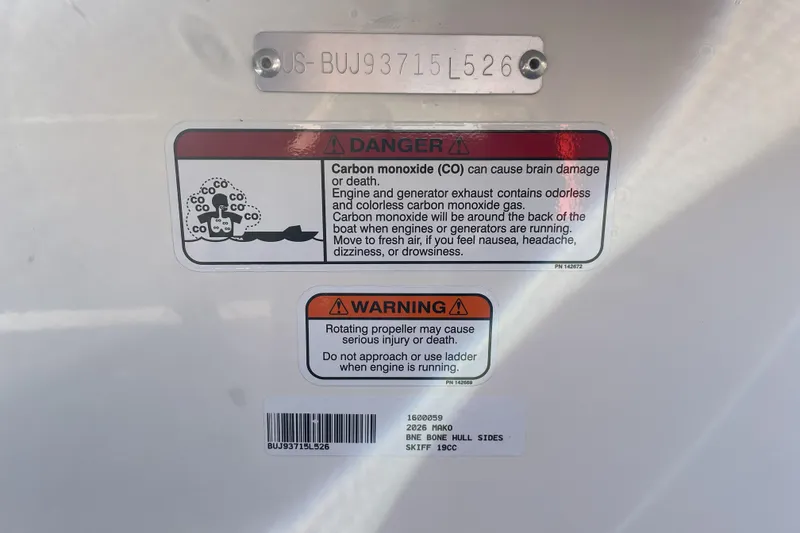 Slide: The Image of Warning labels on 2026 Mako Pro Skiff 19 CC boat, highlighting carbon monoxide and propeller hazards. - 117