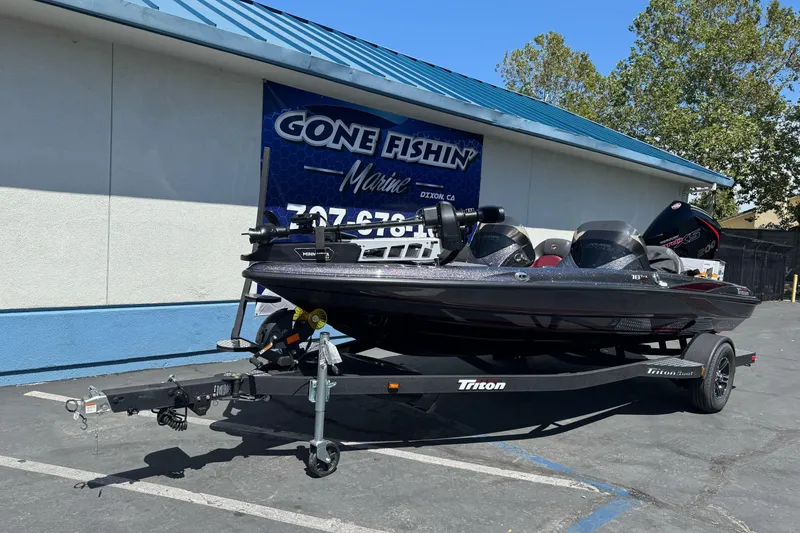 Slide: The Image of 2026 Triton 18 TrX boat on trailer at Gone Fishin' Marine dealership. - 1